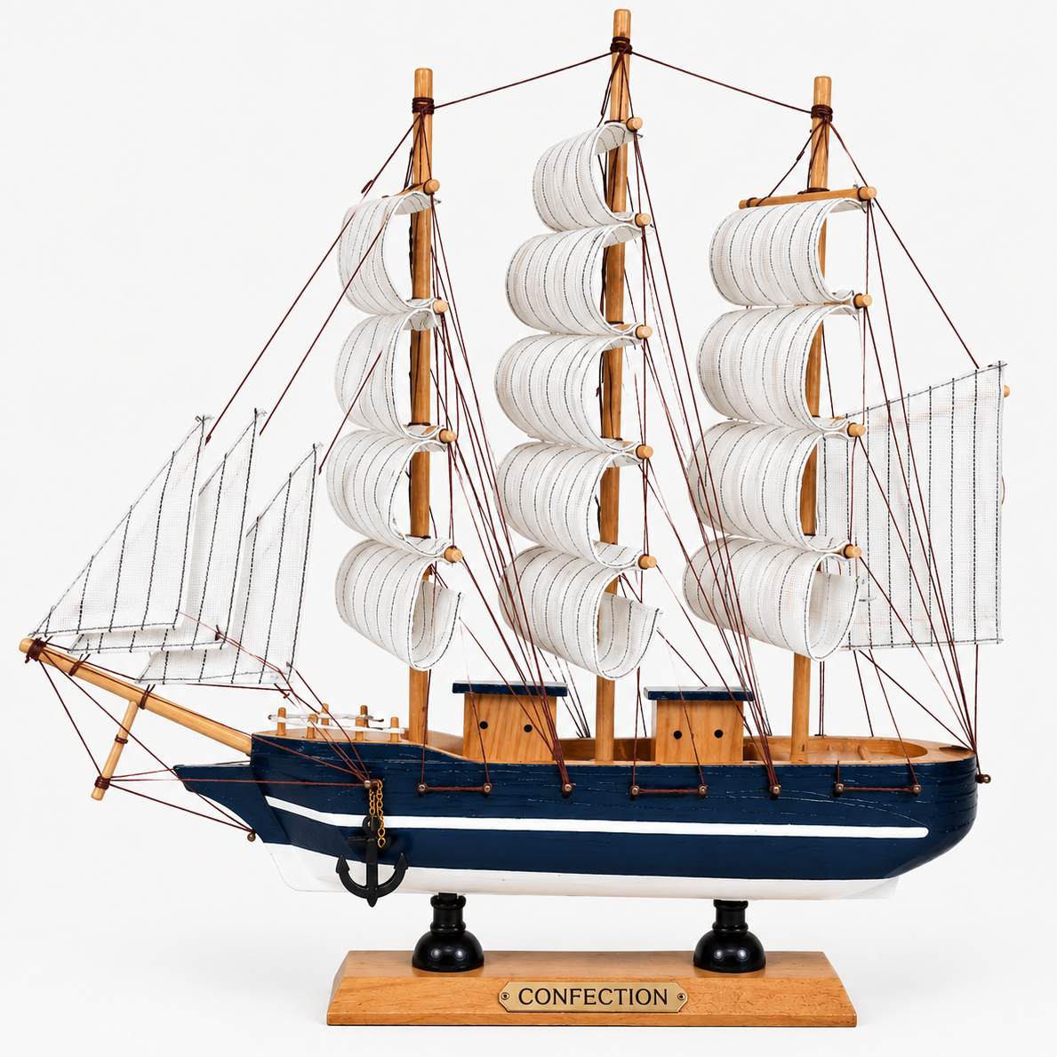 Model ship with multiple sails on a white background
