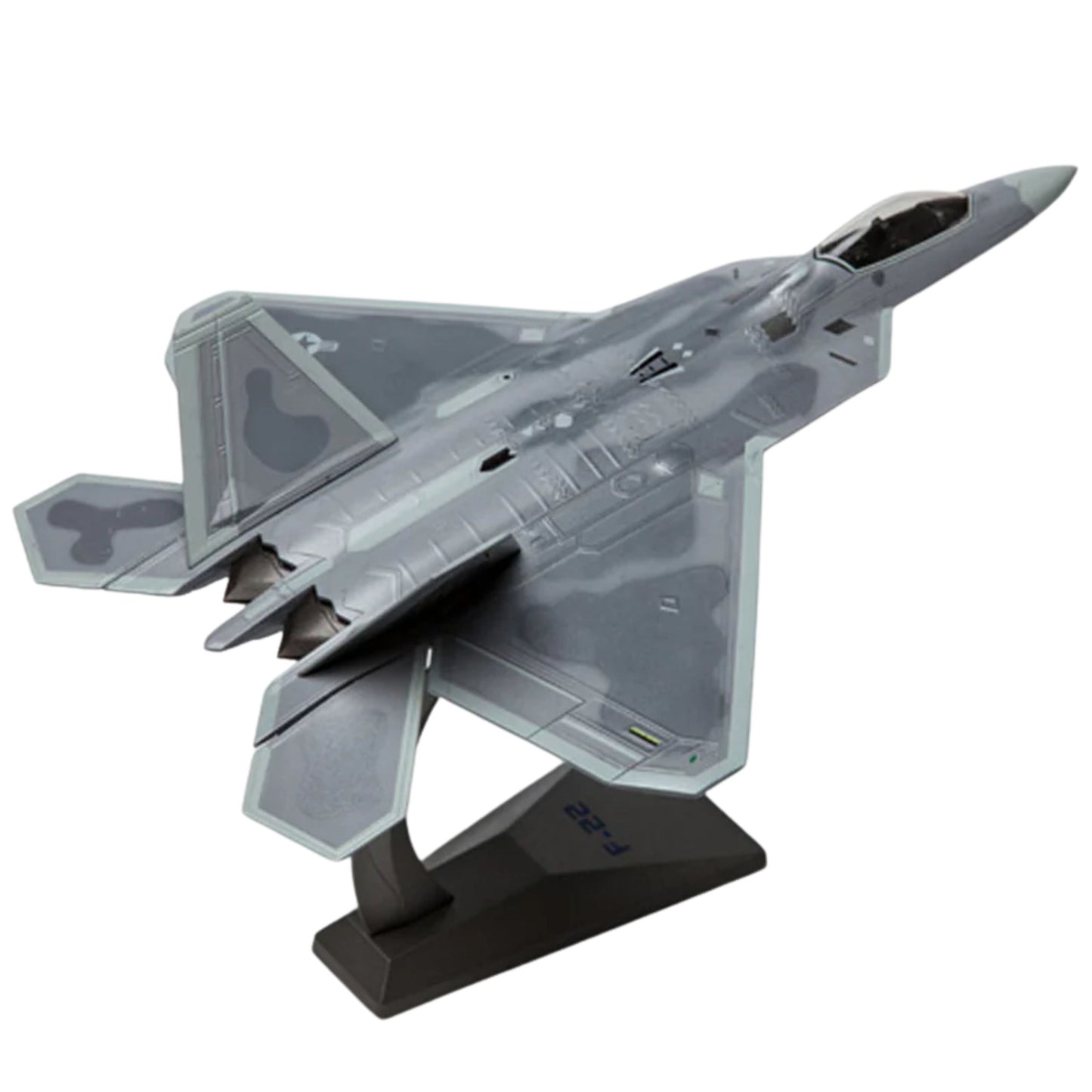Model of a fighter jet on a stand with a white background