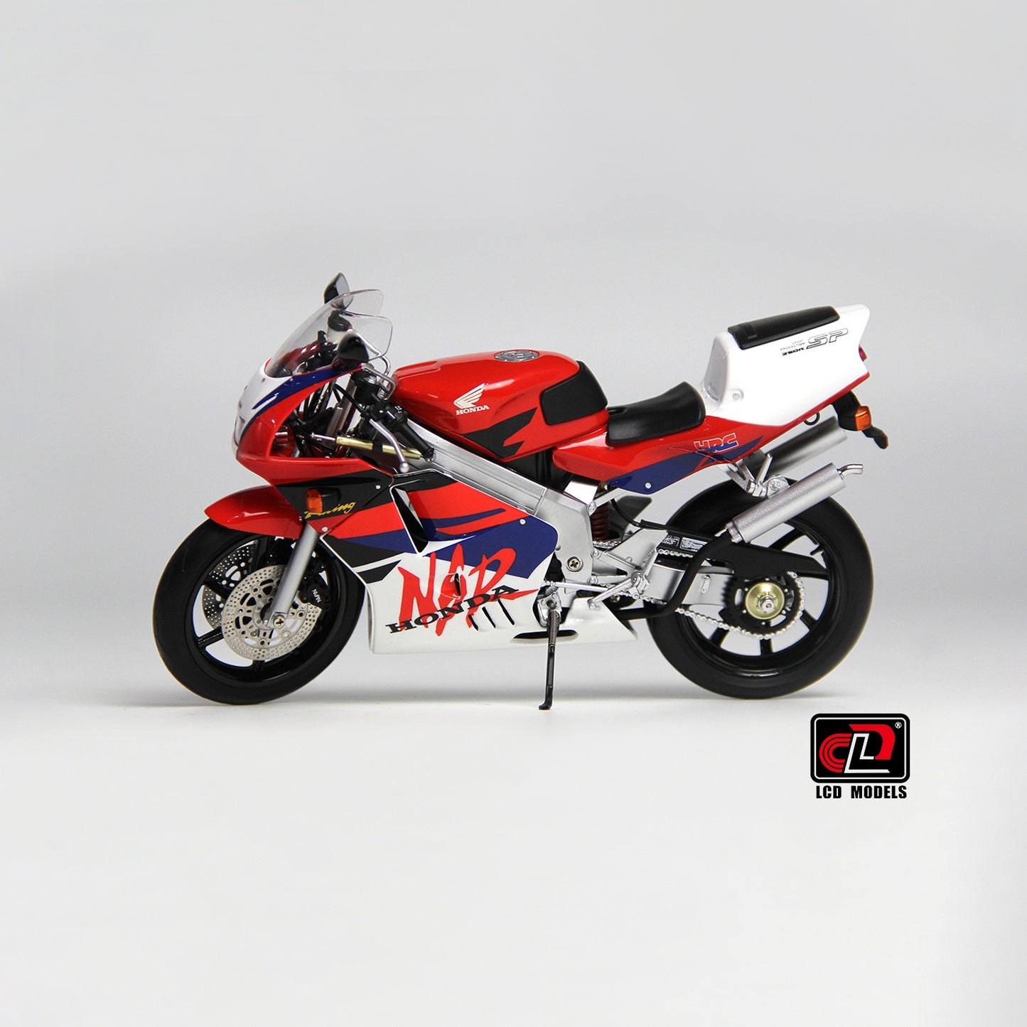 LCD Model motorcycle with red, white, and blue design on a gray background