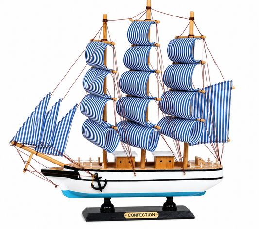 Model ship with blue striped sails on a white background