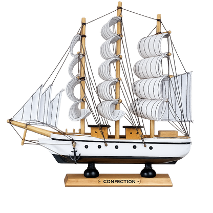 Model ship with multiple sails on a white background