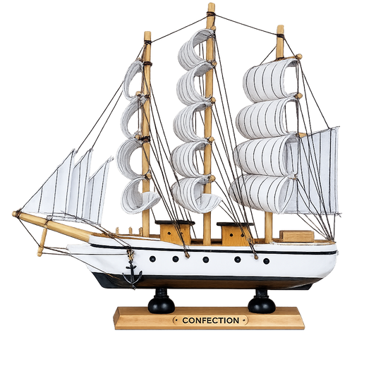 Model ship with multiple sails on a white background