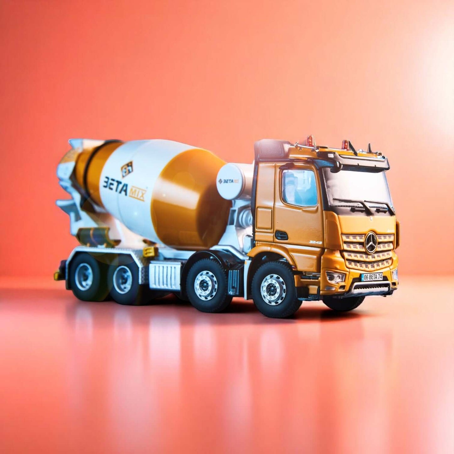 NZG cement mixer truck with 'Beta' branding on an orange background