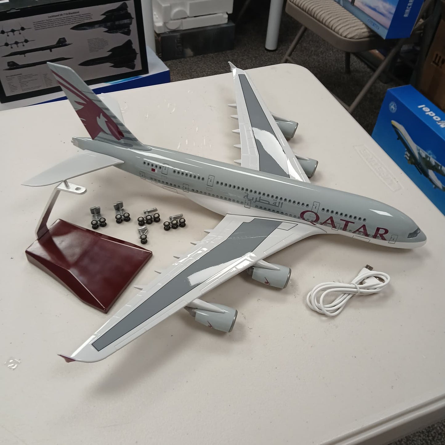 Model airplane with Qatar Airways branding on a table