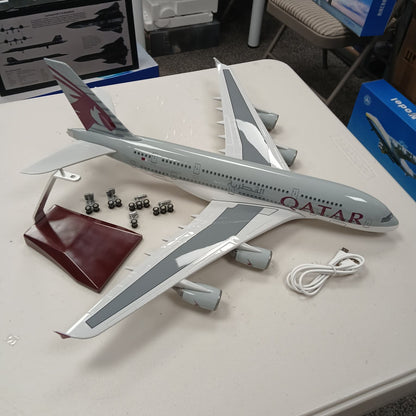 Model airplane with Qatar Airways branding on a table