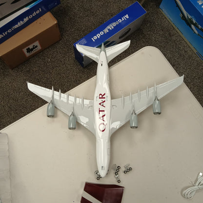 Model airplane with Qatar Airways logo on a table