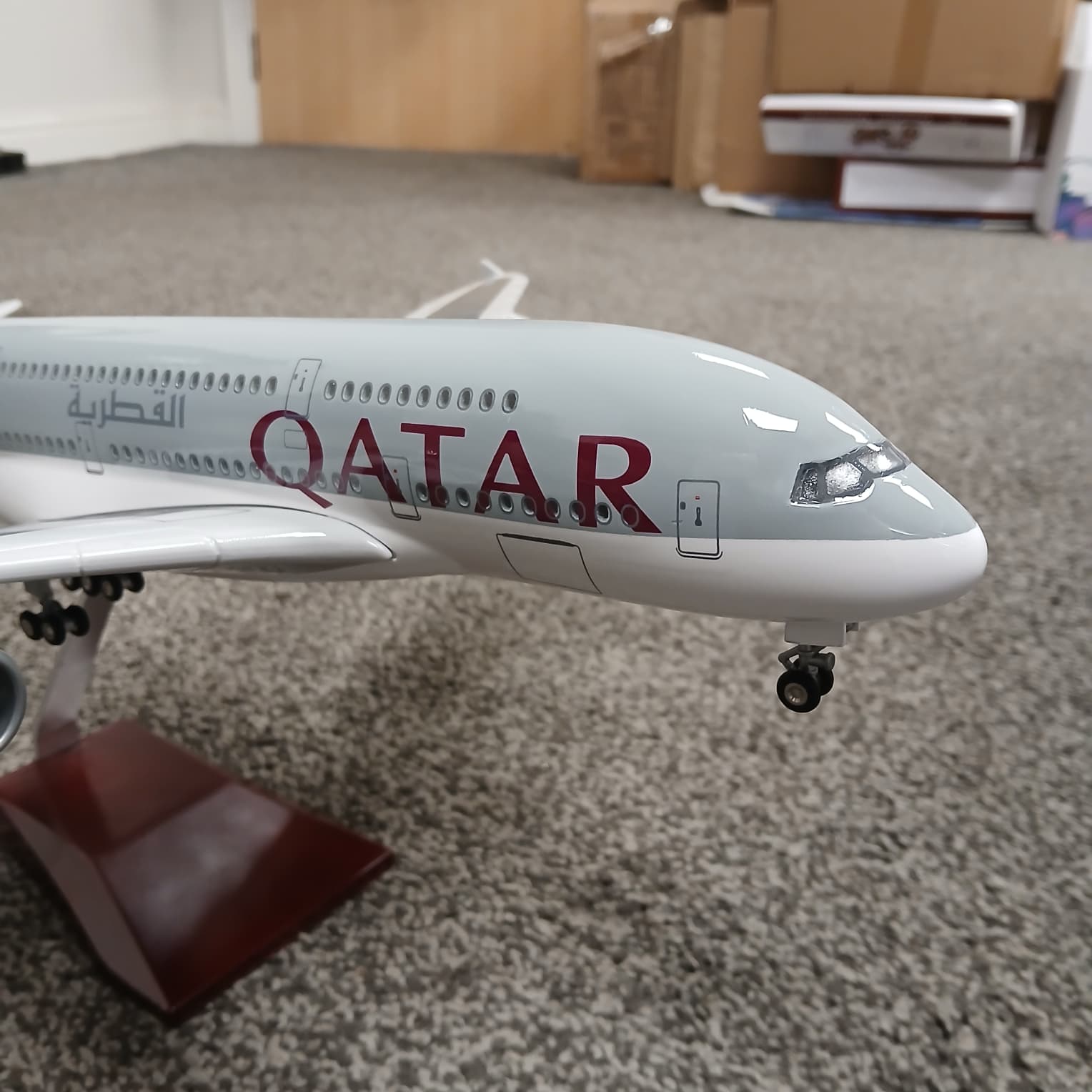 Model of a Qatar Airways airplane on a carpeted floor