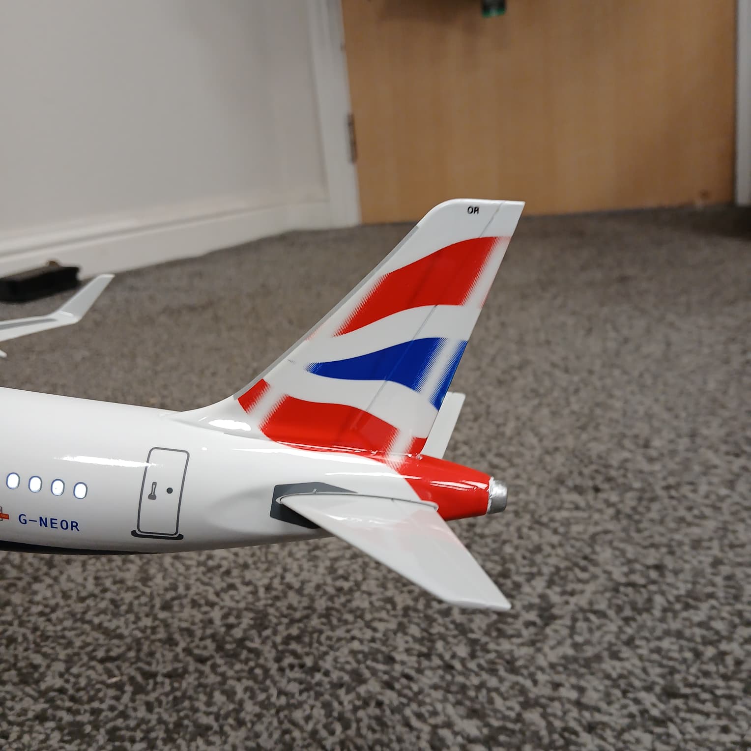 Airbus A321 Model airplane with British Airways logo on a carpeted floor
