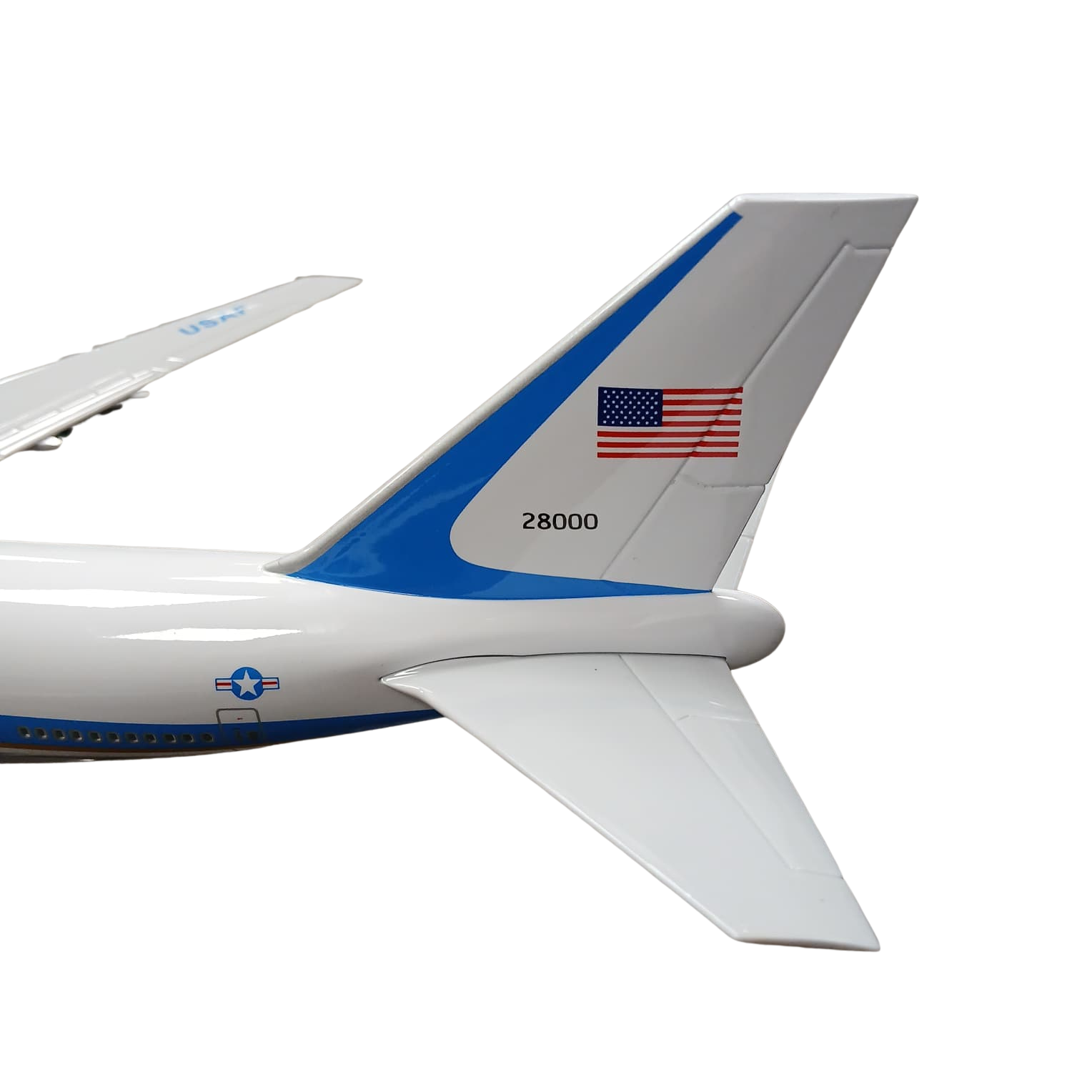 Aircraft tail with American flag and number 28000 on a white background