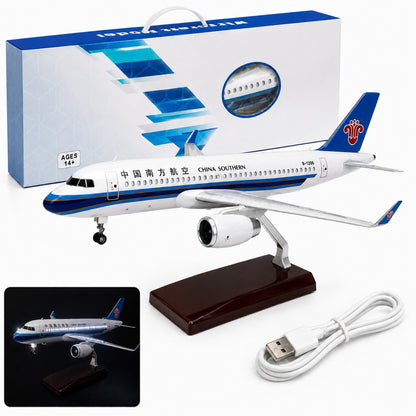 Model airplane with China Southern Airlines branding, packaging, and USB cable on a white background