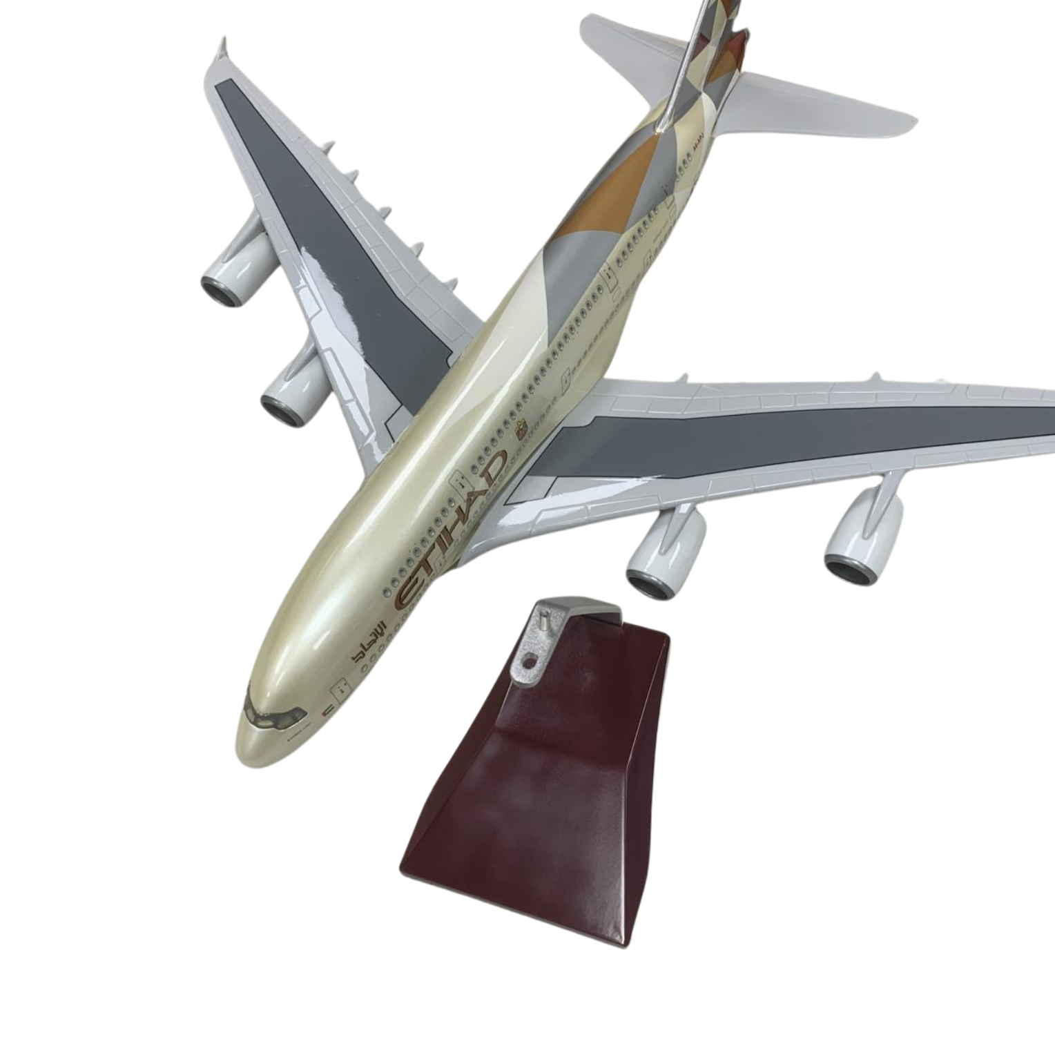 Model airplane on a stand against a white background