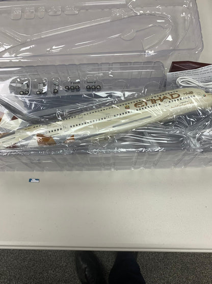 Model airplane in a clear plastic case on a white surface