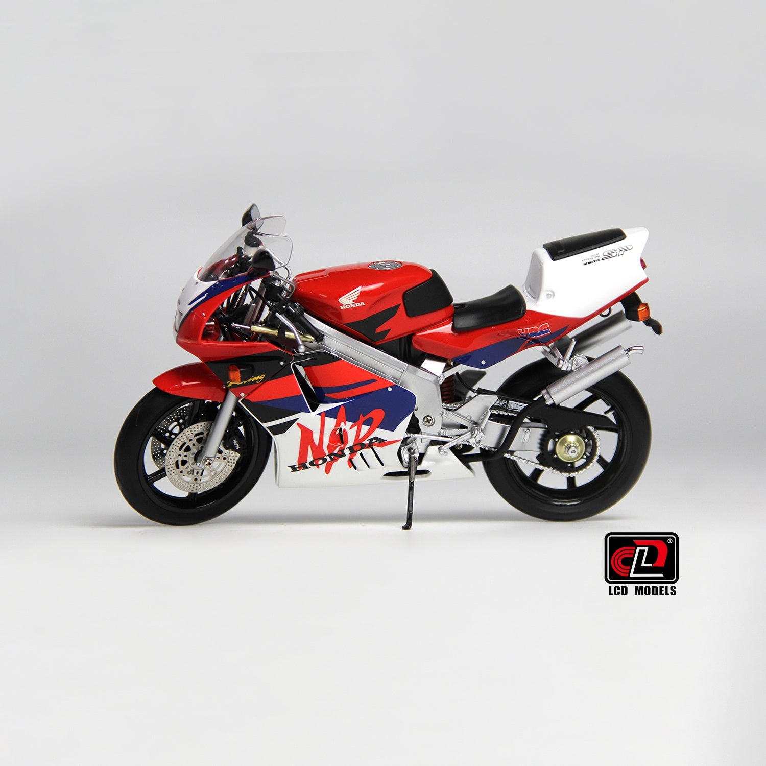 LCD Model motorcycle with red, white, and blue design on a gray background