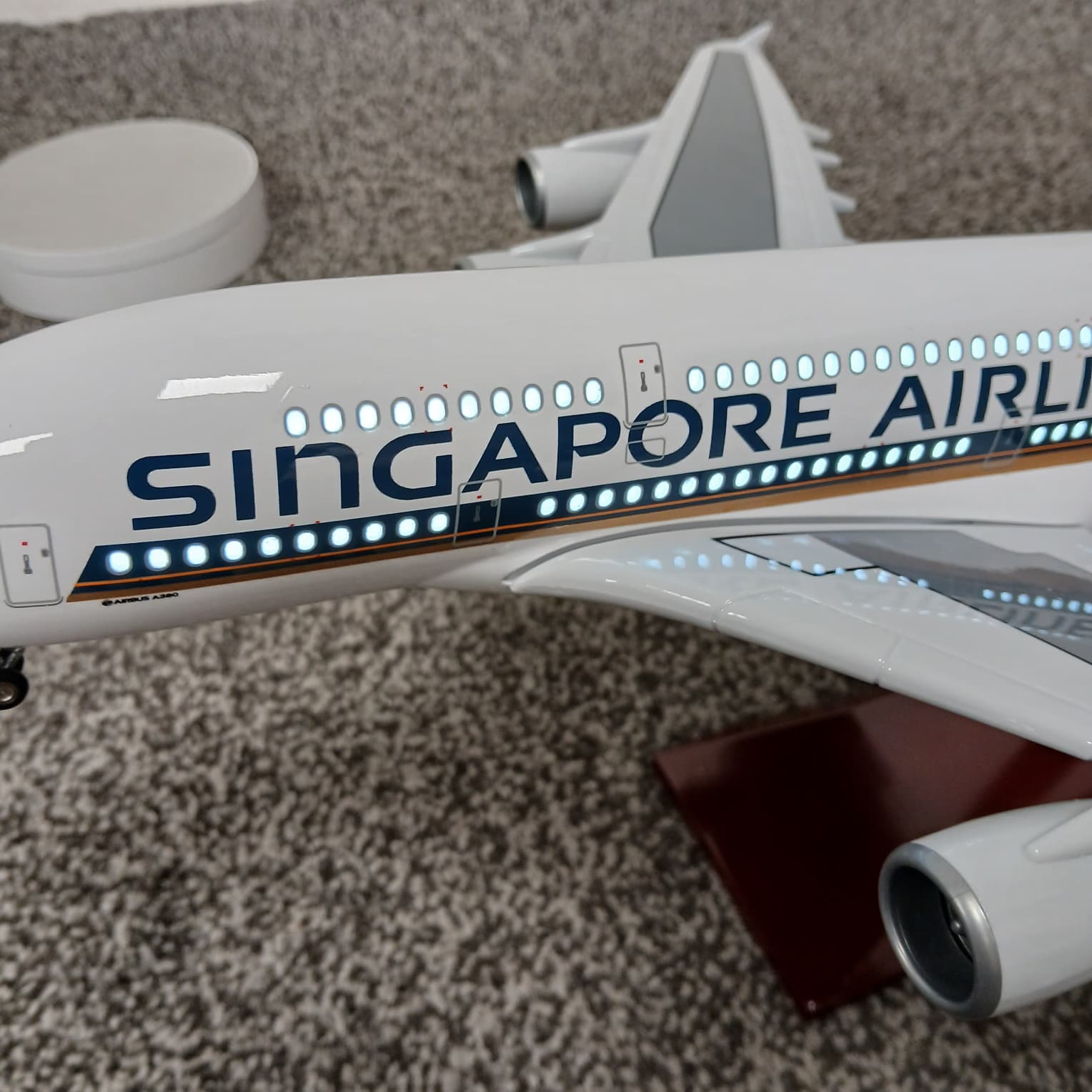 Model of a A380 Singapore Airlines airplane with lights on