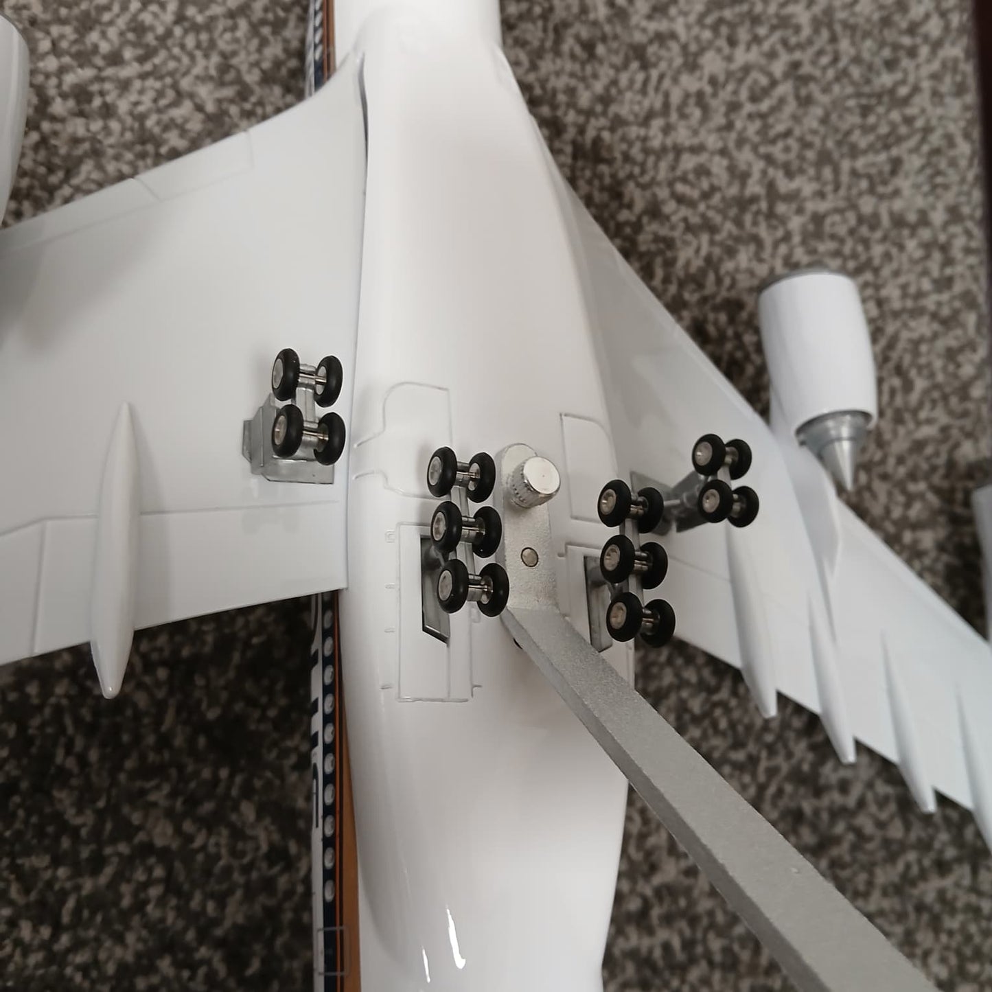 A380 Close-up of a model airplane with detailed parts on a textured surface
