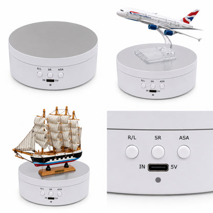 White electronic device with model airplane, ship, and airplane on top, displaying ports and buttons.