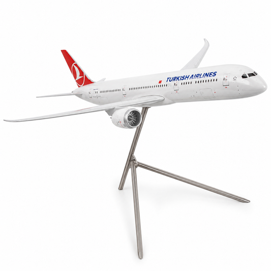 A scale model of a Turkish Airlines passenger airplane on a metallic tripod stand, photographed against a seamless white background.