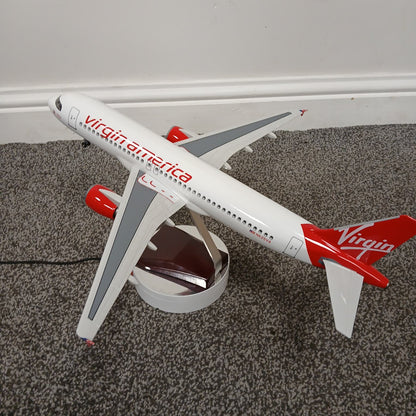 Model airplane with Virgin America branding on a carpeted floor.