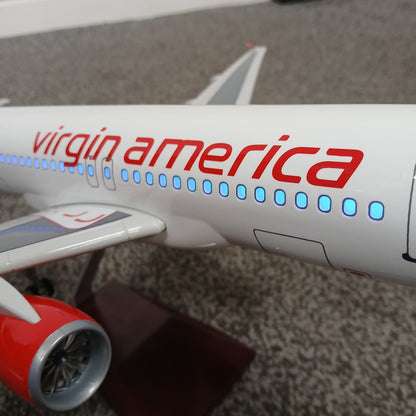 Model airplane with 'virgin america' branding on a textured surface