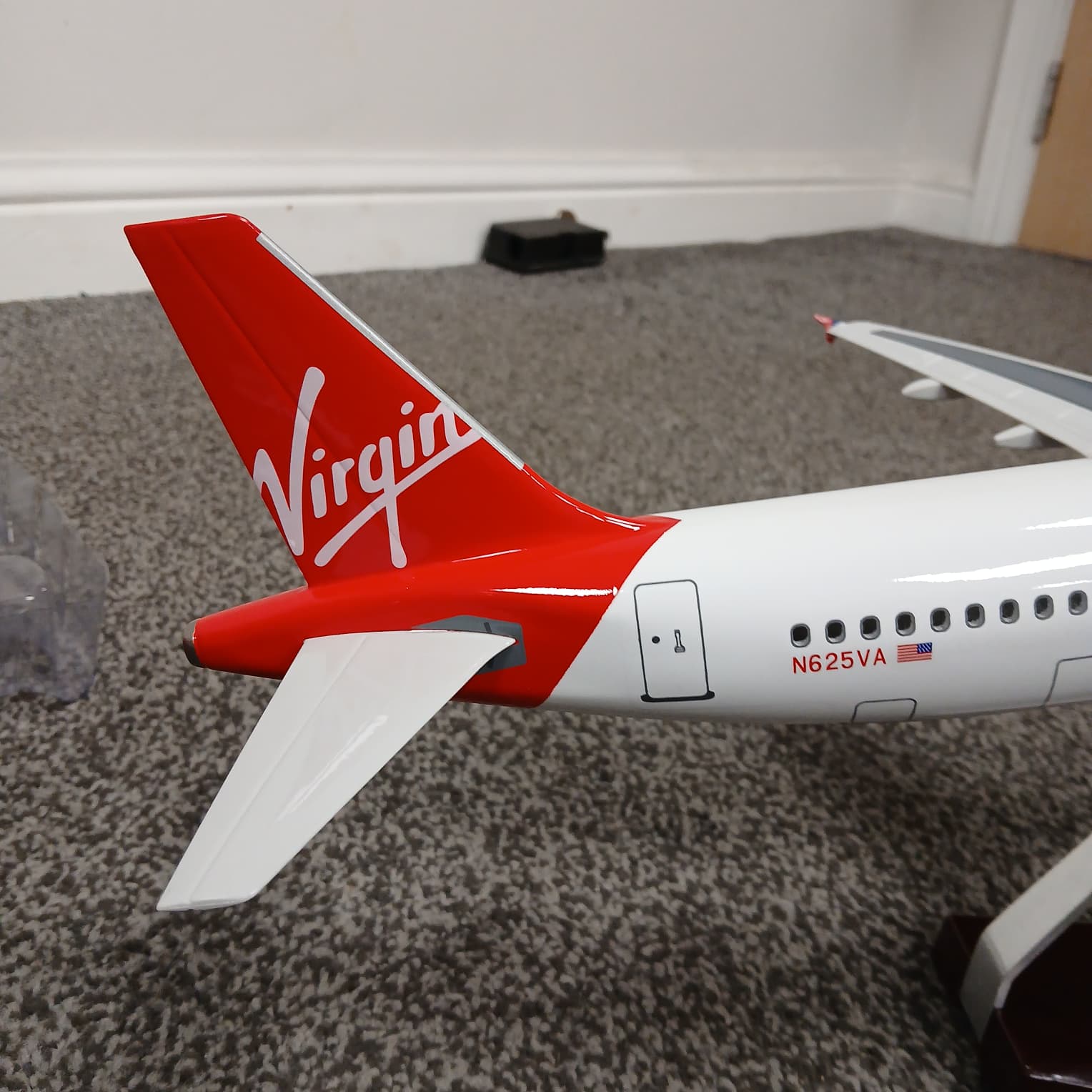 Model airplane with Virgin logo on a carpeted floor