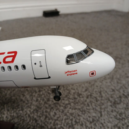 Model airplane with 'Jefferson Airplane' branding on a carpeted floor